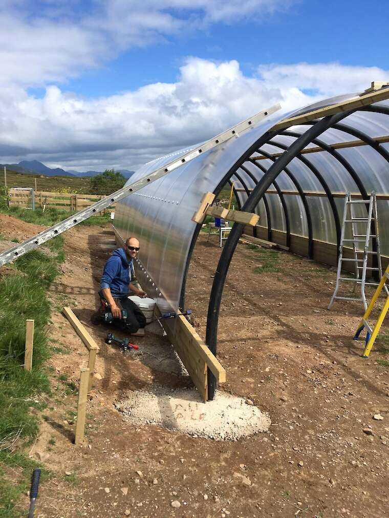 Richard Whatley outside of a Polycrub during the build.
