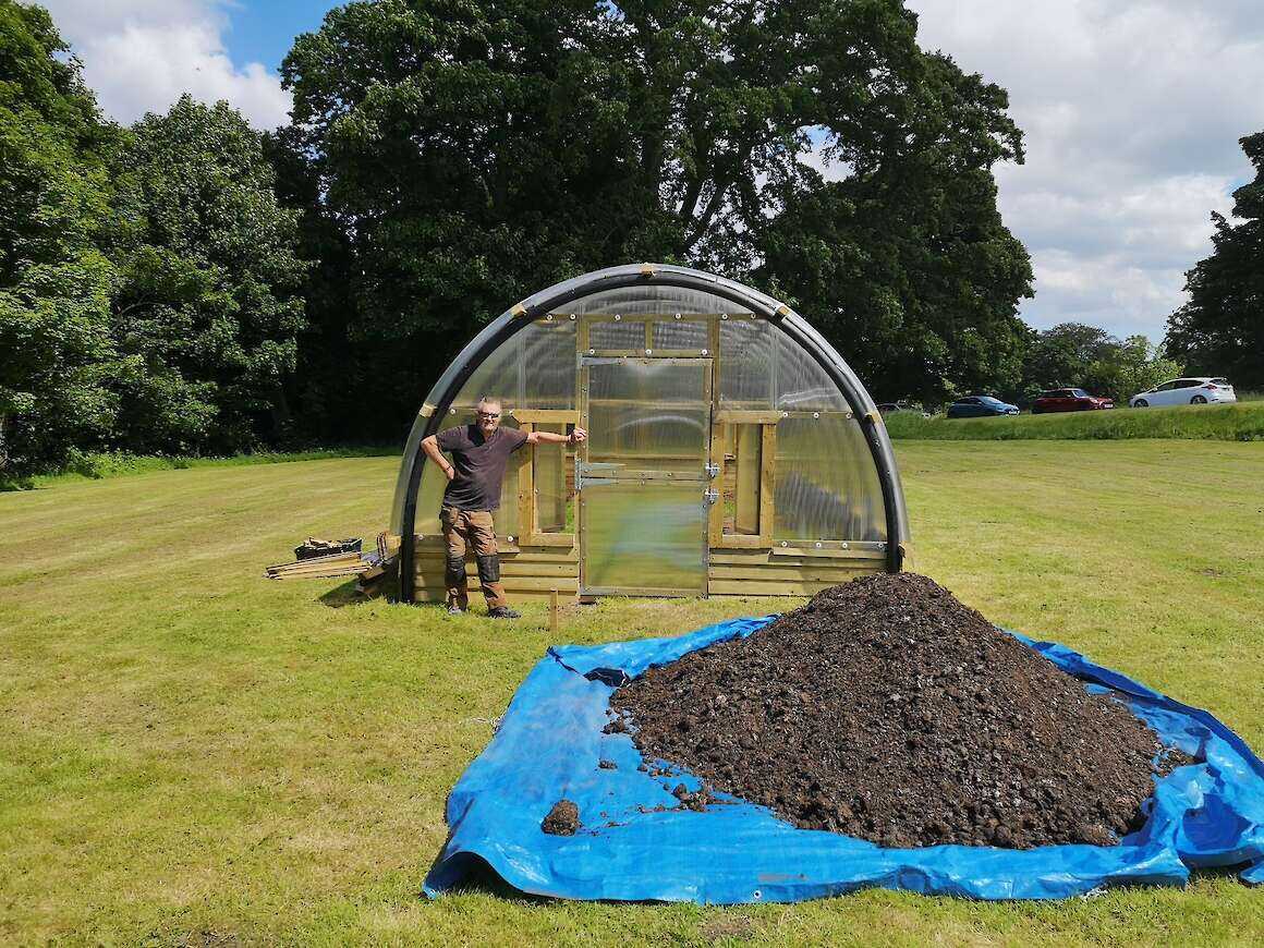 Marc Hanna outside of a newly built Polycrub.